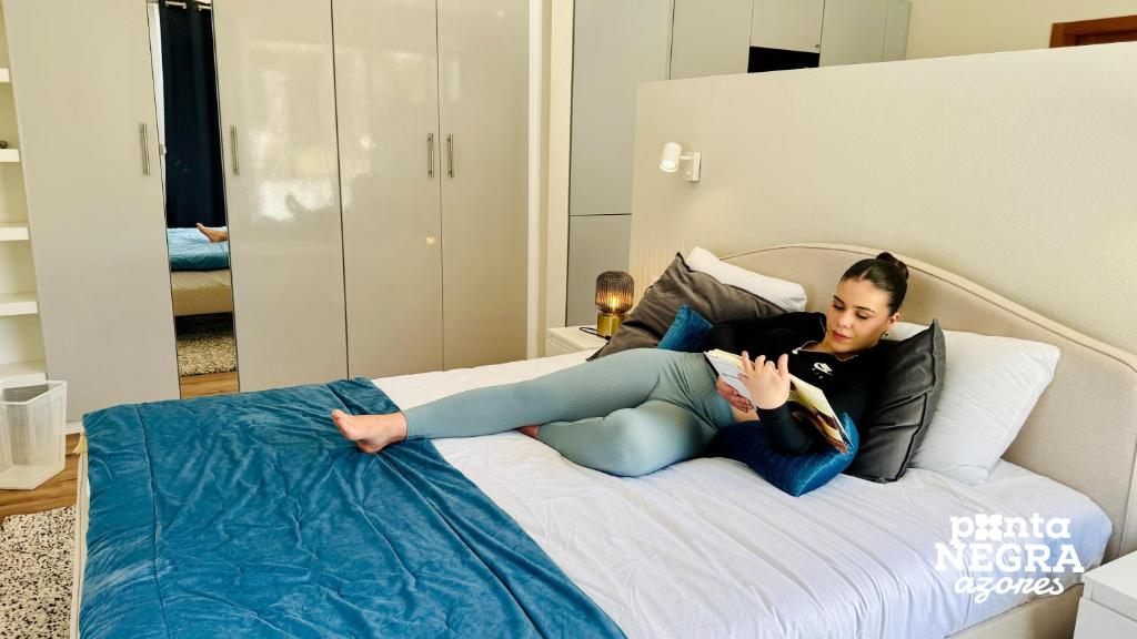Woman reading and relaxing on the bed